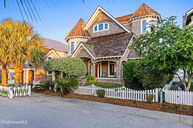 218 Row Boat Row, Bald Head Island, NC 28461 - view of front of house featuring covered porch and a fenced front yard