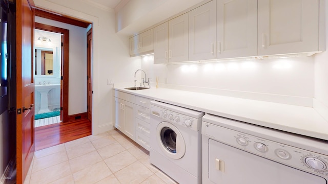 218 Row Boat Row, Bald Head Island, NC 28461 - washroom with independent washer and dryer, cabinet space, light tile patterned flooring, and baseboards