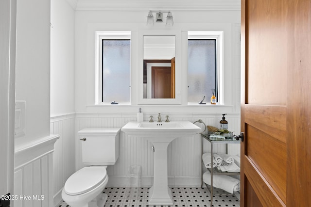218 Row Boat Row, Bald Head Island, NC 28461 - bathroom with toilet, a wainscoted wall, crown molding, and a decorative wall