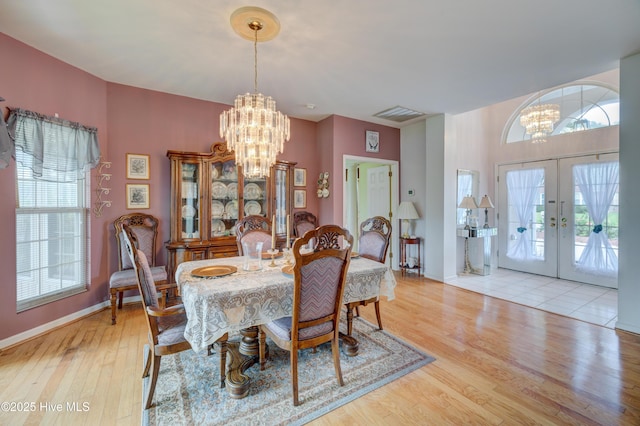 7120 Orchard Trce, Wilmington, NC 28409 - dining area featuring a chandelier, wood finished floors, french doors, and baseboards