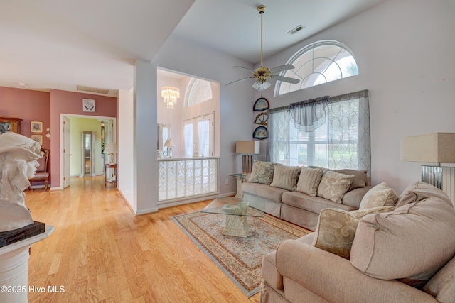 7120 Orchard Trce, Wilmington, NC 28409 - living room featuring light wood-style floors, a ceiling fan, baseboards, and a chandelier
