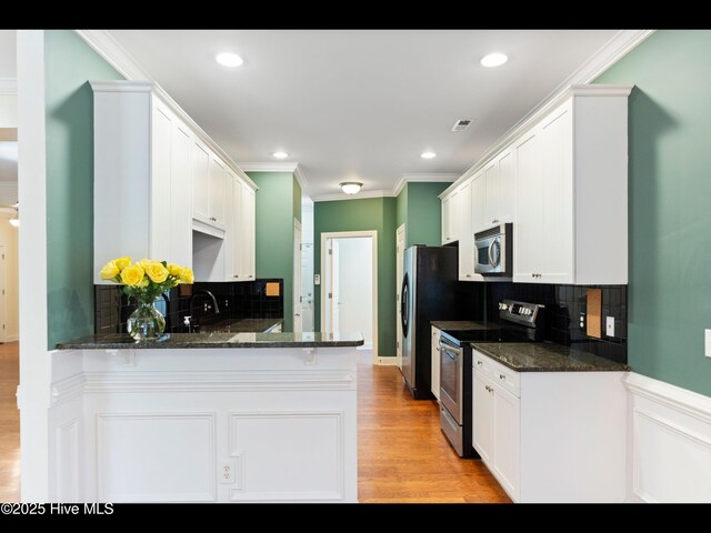 822 Lambrook Dr, Wilmington, NC 28411 - kitchen with stainless steel appliances, ornamental molding, decorative backsplash, white cabinets, and a peninsula