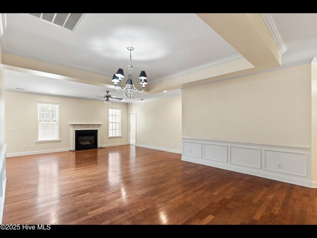 822 Lambrook Dr, Wilmington, NC 28411 - unfurnished living room featuring a chandelier, wood finished floors, crown molding, a premium fireplace, and a ceiling fan