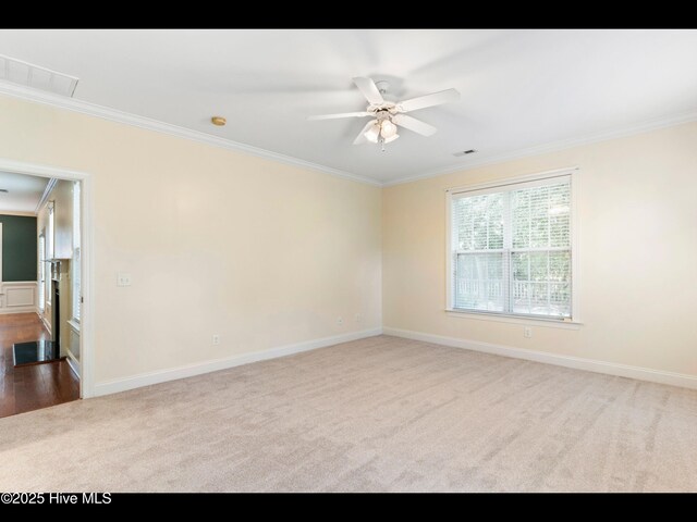 822 Lambrook Dr, Wilmington, NC 28411 - spare room with ornamental molding, dark carpet, ceiling fan, and baseboards
