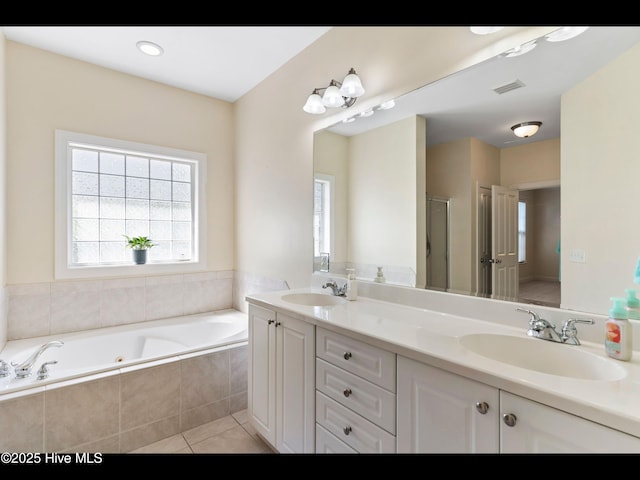 822 Lambrook Dr, Wilmington, NC 28411 - full bathroom featuring double vanity, a whirlpool tub, healthy amount of natural light, and tile patterned floors