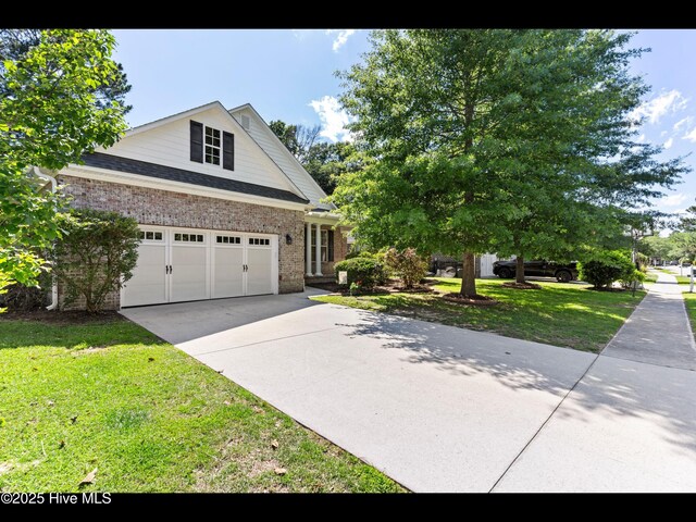 822 Lambrook Dr, Wilmington, NC 28411 - view of front facade with concrete driveway, brick siding, and a front yard