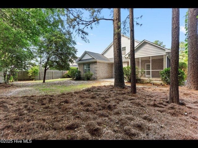 822 Lambrook Dr, Wilmington, NC 28411 - view of front of property with a sunroom and brick siding