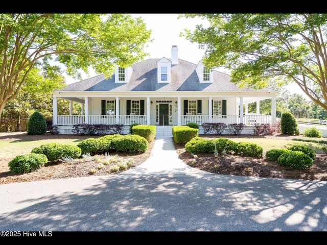 822 Lambrook Dr, Wilmington, NC 28411 - view of front of house with a porch and a chimney