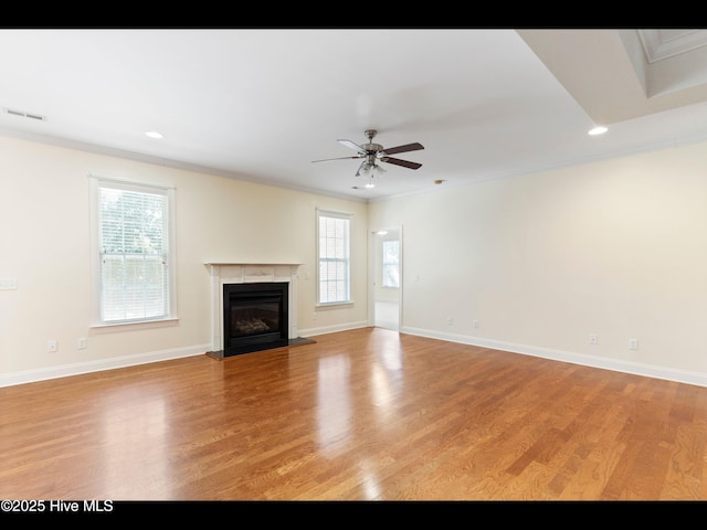 822 Lambrook Dr, Wilmington, NC 28411 - unfurnished living room featuring healthy amount of natural light, a ceiling fan, light wood-style floors, ornamental molding, and recessed lighting