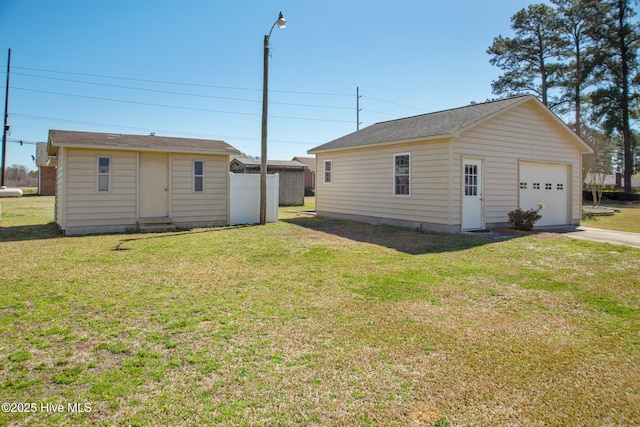 3007 Camelot Dr, Kinston, NC 28504 - back of property featuring an outdoor structure, a lawn, and concrete driveway