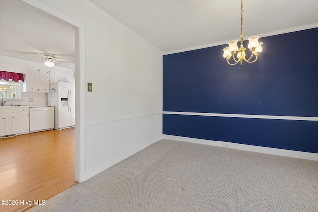 3007 Camelot Dr, Kinston, NC 28504 - empty room featuring a chandelier, crown molding, ceiling fan, a sink, and baseboards