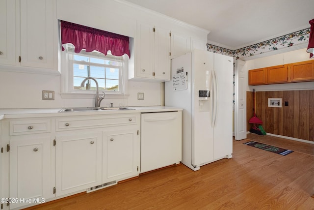 3007 Camelot Dr, Kinston, NC 28504 - kitchen featuring white appliances, a sink, light wood finished floors, light countertops, and white cabinets