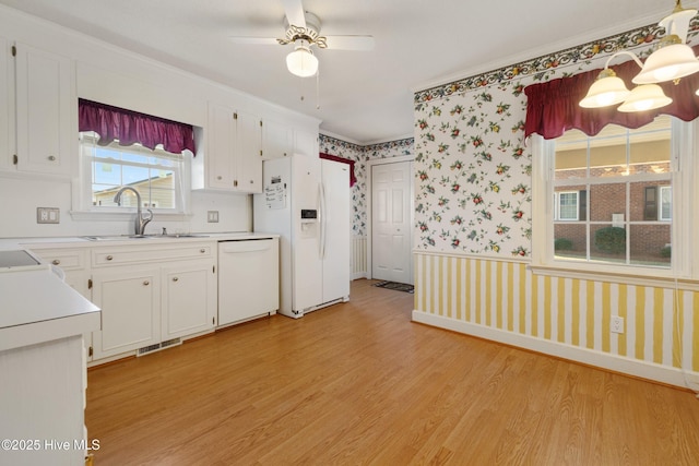 3007 Camelot Dr, Kinston, NC 28504 - kitchen with white appliances, wallpapered walls, a sink, light wood-style flooring, and light countertops