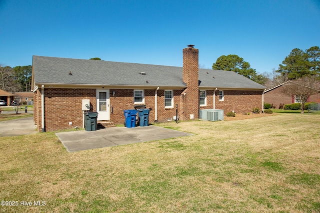 3007 Camelot Dr, Kinston, NC 28504 - back of house with a chimney, a yard, brick siding, cooling unit, and roof with shingles