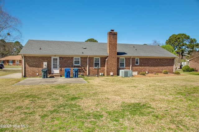 3007 Camelot Dr, Kinston, NC 28504 - rear view of house with a patio area, a chimney, a lawn, and cooling unit