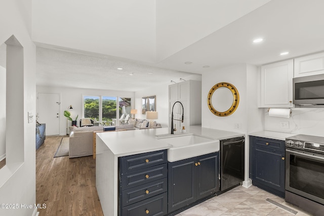 2106 E Fort Macon Rd Unit 310Tar, Atlantic Beach, NC 28512 - kitchen with appliances with stainless steel finishes, a sink, a peninsula, open floor plan, and recessed lighting