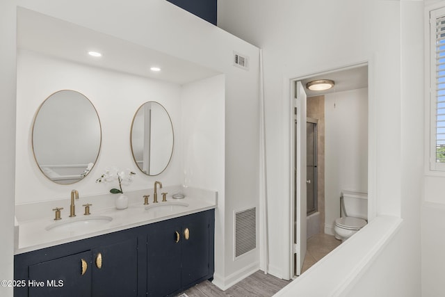 2106 E Fort Macon Rd Unit 310Tar, Atlantic Beach, NC 28512 - bathroom featuring double vanity, toilet, combined bath / shower with glass door, and baseboards