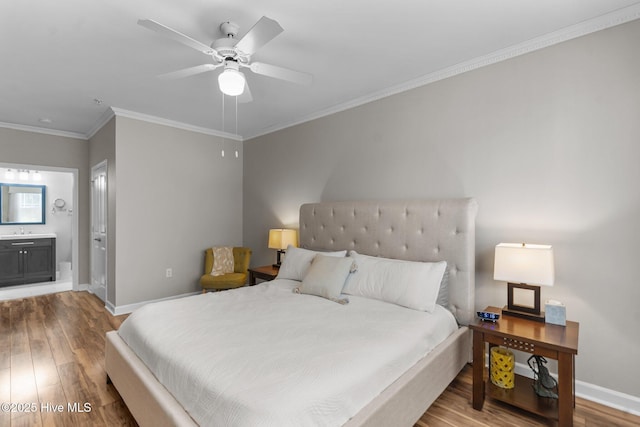 395 S Crow Creek Dr Unit 1511, Calabash, NC 28467 - bedroom featuring wood finished floors, baseboards, a sink, crown molding, and ensuite bath