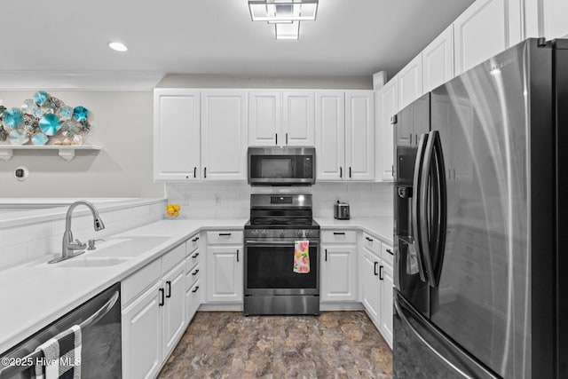 395 S Crow Creek Dr Unit 1511, Calabash, NC 28467 - kitchen featuring appliances with stainless steel finishes, a sink, white cabinets, backsplash, and recessed lighting