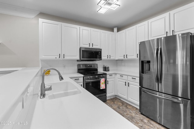 395 S Crow Creek Dr Unit 1511, Calabash, NC 28467 - kitchen featuring appliances with stainless steel finishes, a sink, white cabinets, light countertops, and backsplash