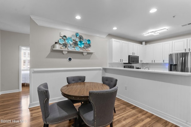 395 S Crow Creek Dr Unit 1511, Calabash, NC 28467 - dining space with dark wood-style floors, recessed lighting, crown molding, and baseboards