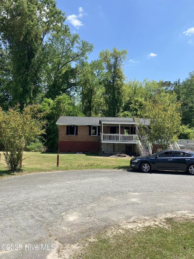 505 Washington St, Windsor, NC 27983 - view of front facade with a front lawn, brick siding, and crawl space