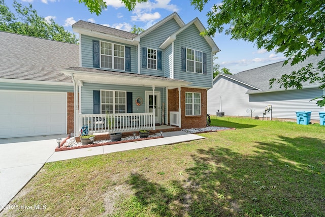 218 Yearling Loop, Jacksonville, NC 28540 - traditional-style house with covered porch, brick siding, an attached garage, a front yard, and concrete driveway
