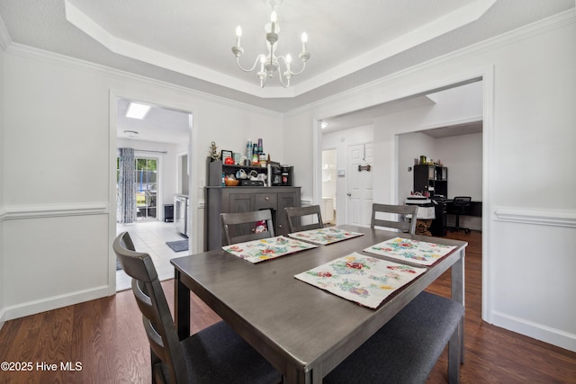 218 Yearling Loop, Jacksonville, NC 28540 - dining space featuring a chandelier, a tray ceiling, dark wood finished floors, an office area, and crown molding