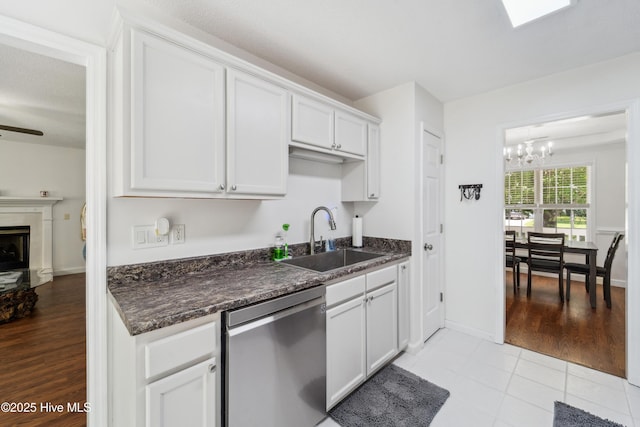 218 Yearling Loop, Jacksonville, NC 28540 - kitchen with dishwasher, a sink, a chandelier, white cabinetry, and light tile patterned flooring