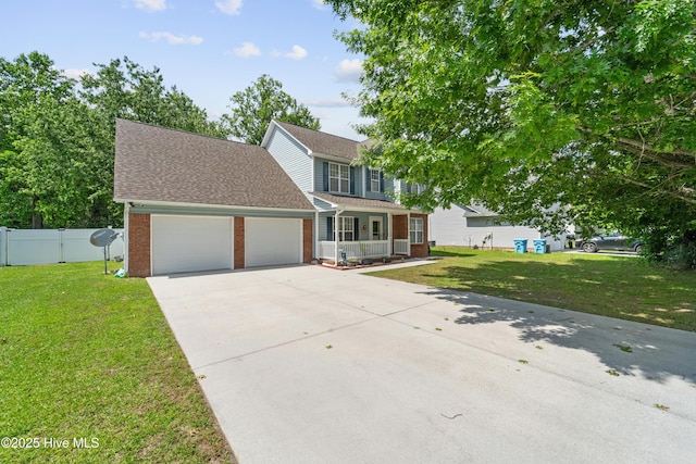 218 Yearling Loop, Jacksonville, NC 28540 - colonial house with covered porch, brick siding, a garage, driveway, and roof with shingles