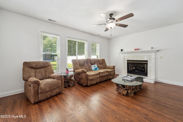 218 Yearling Loop, Jacksonville, NC 28540 - living area featuring a ceiling fan, wood finished floors, baseboards, and a fireplace with raised hearth