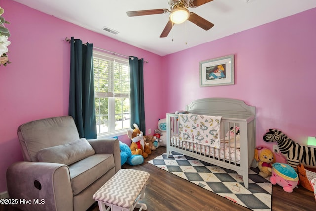218 Yearling Loop, Jacksonville, NC 28540 - bedroom with wood finished floors, ceiling fan, and a nursery area