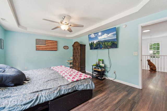 218 Yearling Loop, Jacksonville, NC 28540 - bedroom with a tray ceiling, dark wood-style floors, baseboards, and a ceiling fan