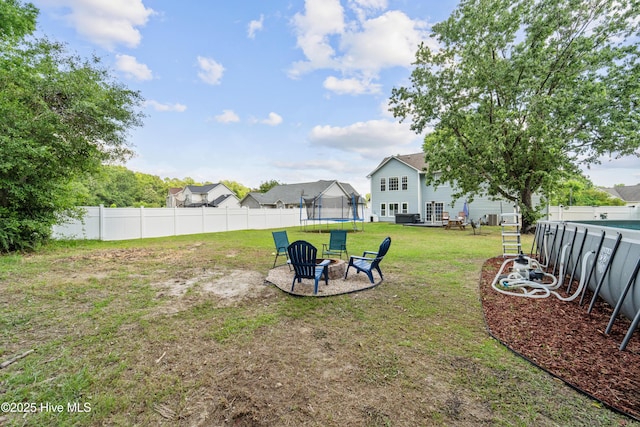 218 Yearling Loop, Jacksonville, NC 28540 - view of yard with a trampoline and a fire pit