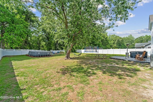 218 Yearling Loop, Jacksonville, NC 28540 - view of yard with a trampoline and a deck