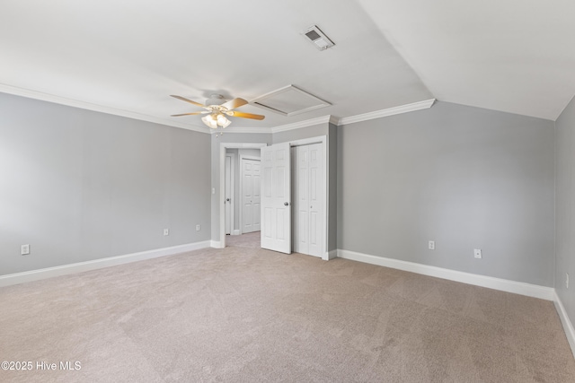 2415 Circle St, Wilmington, NC 28403 - unfurnished bedroom with light colored carpet, crown molding, attic access, baseboards, and lofted ceiling