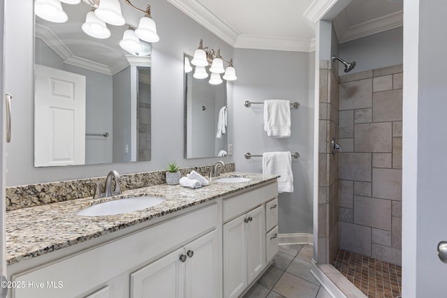 2415 Circle St, Wilmington, NC 28403 - bathroom with double vanity, a tile shower, ornamental molding, baseboards, and tile patterned floors