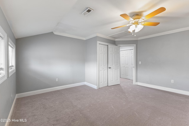 2415 Circle St, Wilmington, NC 28403 - unfurnished bedroom featuring baseboards, carpet flooring, vaulted ceiling, a closet, and a ceiling fan