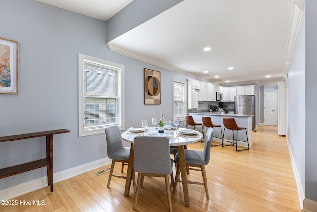 2415 Circle St, Wilmington, NC 28403 - dining space with baseboards, ornamental molding, recessed lighting, and light wood-style flooring