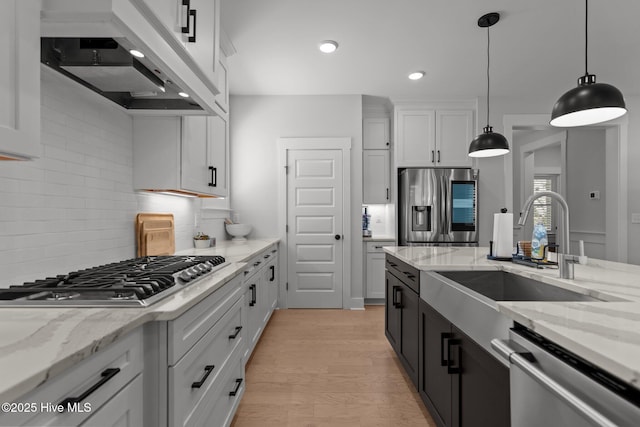 3625 Mason Port Dr, Wilmington, NC 28409 - kitchen with appliances with stainless steel finishes, custom range hood, a sink, decorative light fixtures, and backsplash