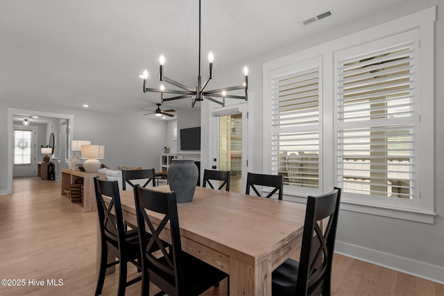 3625 Mason Port Dr, Wilmington, NC 28409 - dining room featuring a chandelier, light wood-type flooring, ceiling fan, and baseboards