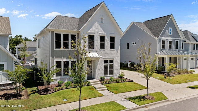 3625 Mason Port Dr, Wilmington, NC 28409 - modern farmhouse style home featuring a front lawn, a shingled roof, a standing seam roof, and concrete driveway