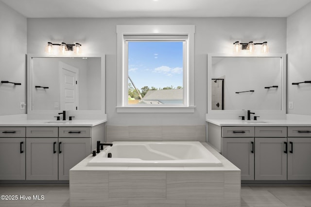 3625 Mason Port Dr, Wilmington, NC 28409 - full bathroom with two vanities, a garden tub, and tile patterned flooring