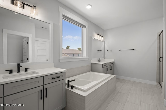 3625 Mason Port Dr, Wilmington, NC 28409 - full bath with two vanities, a shower stall, a bath, and baseboards