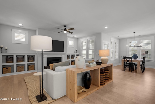 3625 Mason Port Dr, Wilmington, NC 28409 - living room featuring a chandelier, light wood finished floors, a fireplace, ceiling fan, and recessed lighting