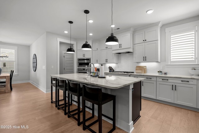 3625 Mason Port Dr, Wilmington, NC 28409 - kitchen with tasteful backsplash, light wood-style floors, light stone countertops, baseboards, and recessed lighting