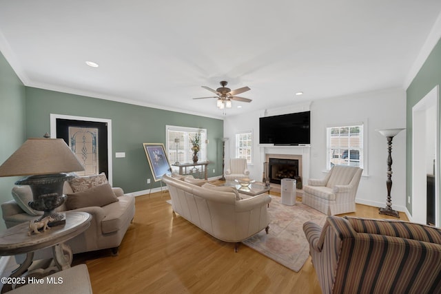 6428 Salem Ridge Dr, Grifton, NC 28530 - living room with light wood-style flooring, baseboards, a fireplace, crown molding, and ceiling fan