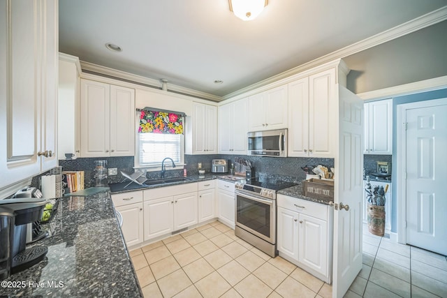 6428 Salem Ridge Dr, Grifton, NC 28530 - kitchen featuring appliances with stainless steel finishes, a sink, light tile patterned flooring, white cabinetry, and ornamental molding
