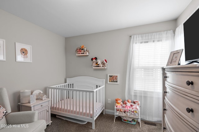 905 Sebring Dr, Winterville, NC 28590 - bedroom featuring a crib, multiple windows, dark carpet, and baseboards