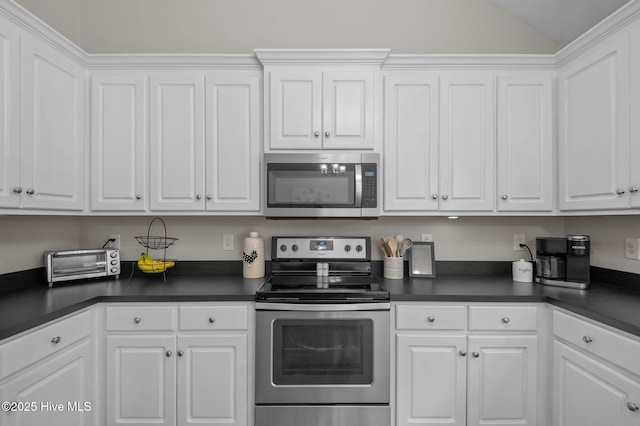 905 Sebring Dr, Winterville, NC 28590 - kitchen with stainless steel appliances, dark countertops, vaulted ceiling, and white cabinets